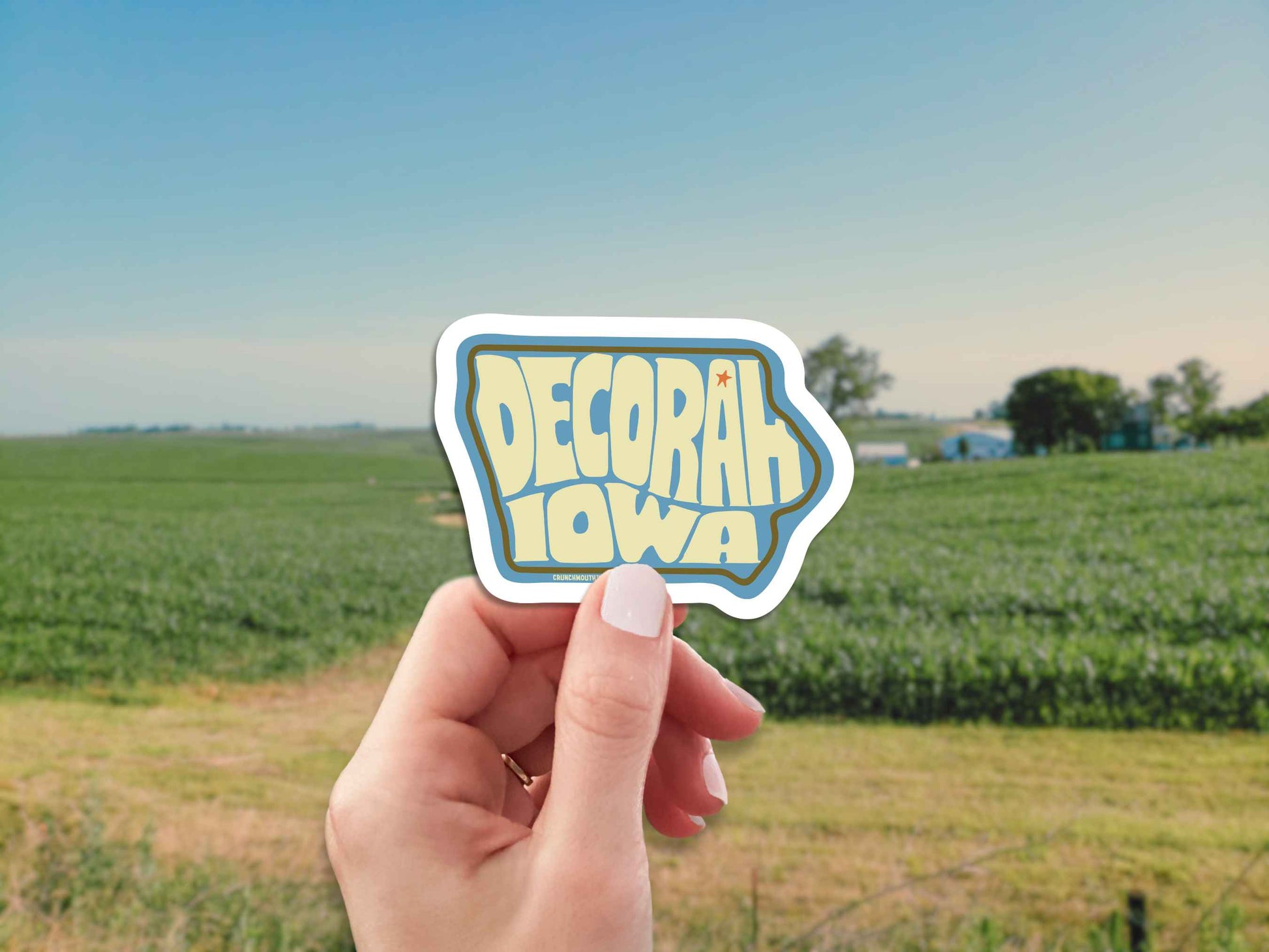 decorah iowa travel luggage sticker, hand display, farm landscape background