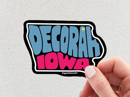 decorah sticker, travel luggage stickers, hand display, light color textured background