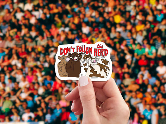 don't follow the herd sticker, hand display, crowd background