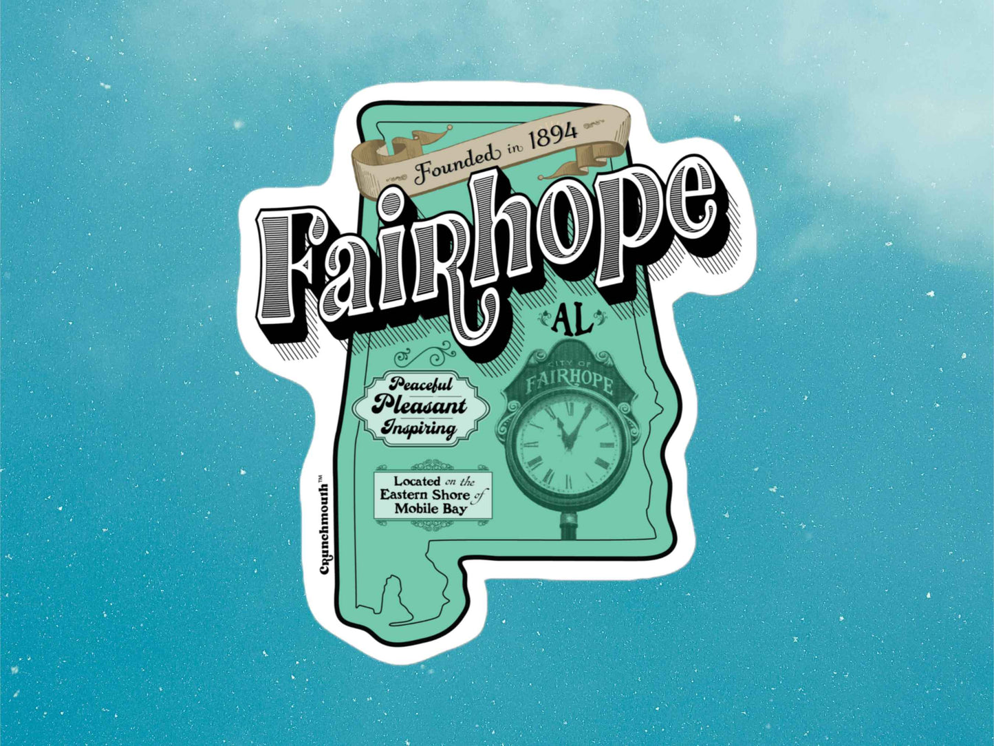 fairhope sticker, hand display, blue sky background