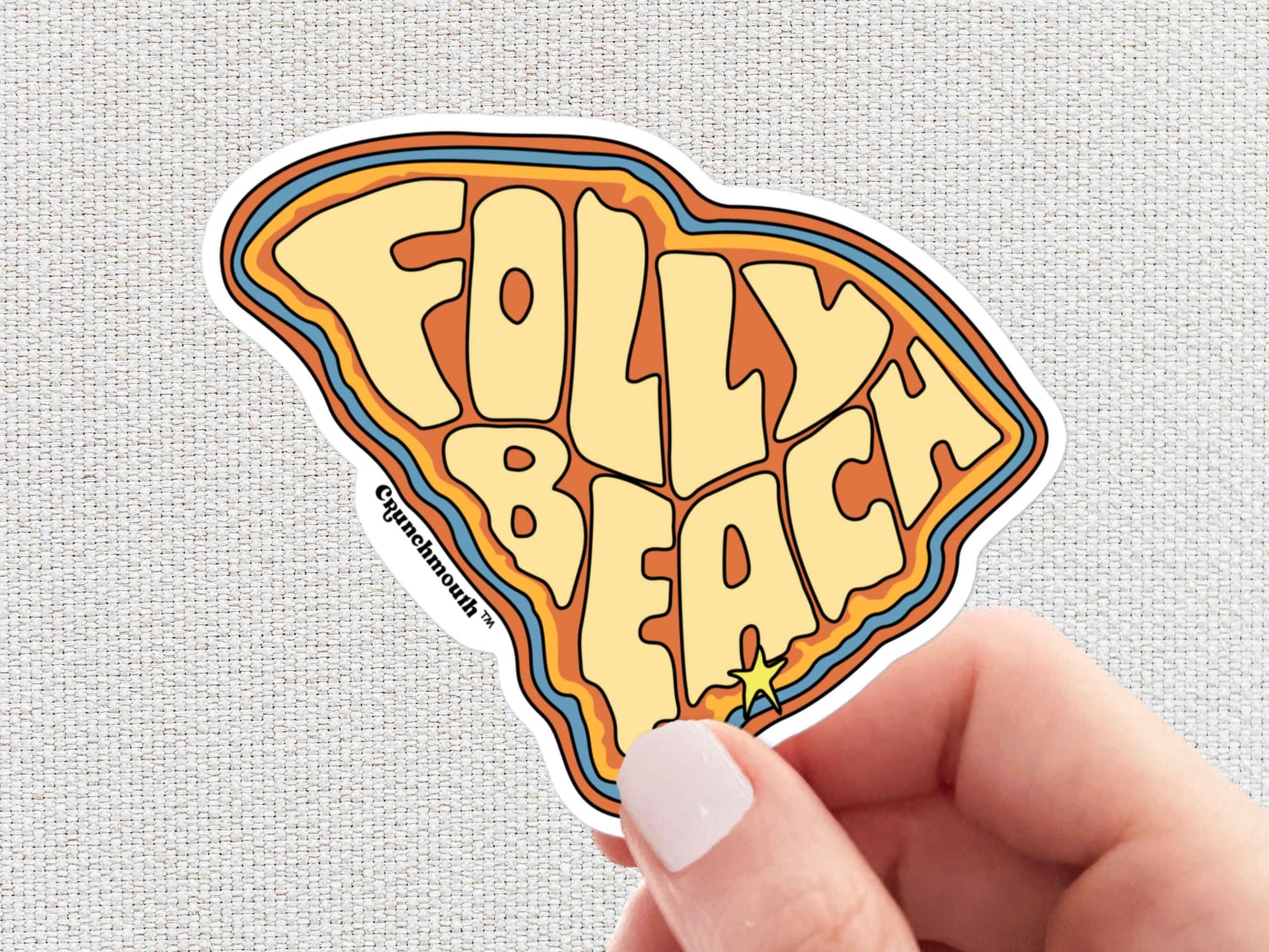 folly beach sticker, hand display, white textured background