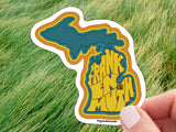 frankenmuth michigan sticker, held in hand, grass background