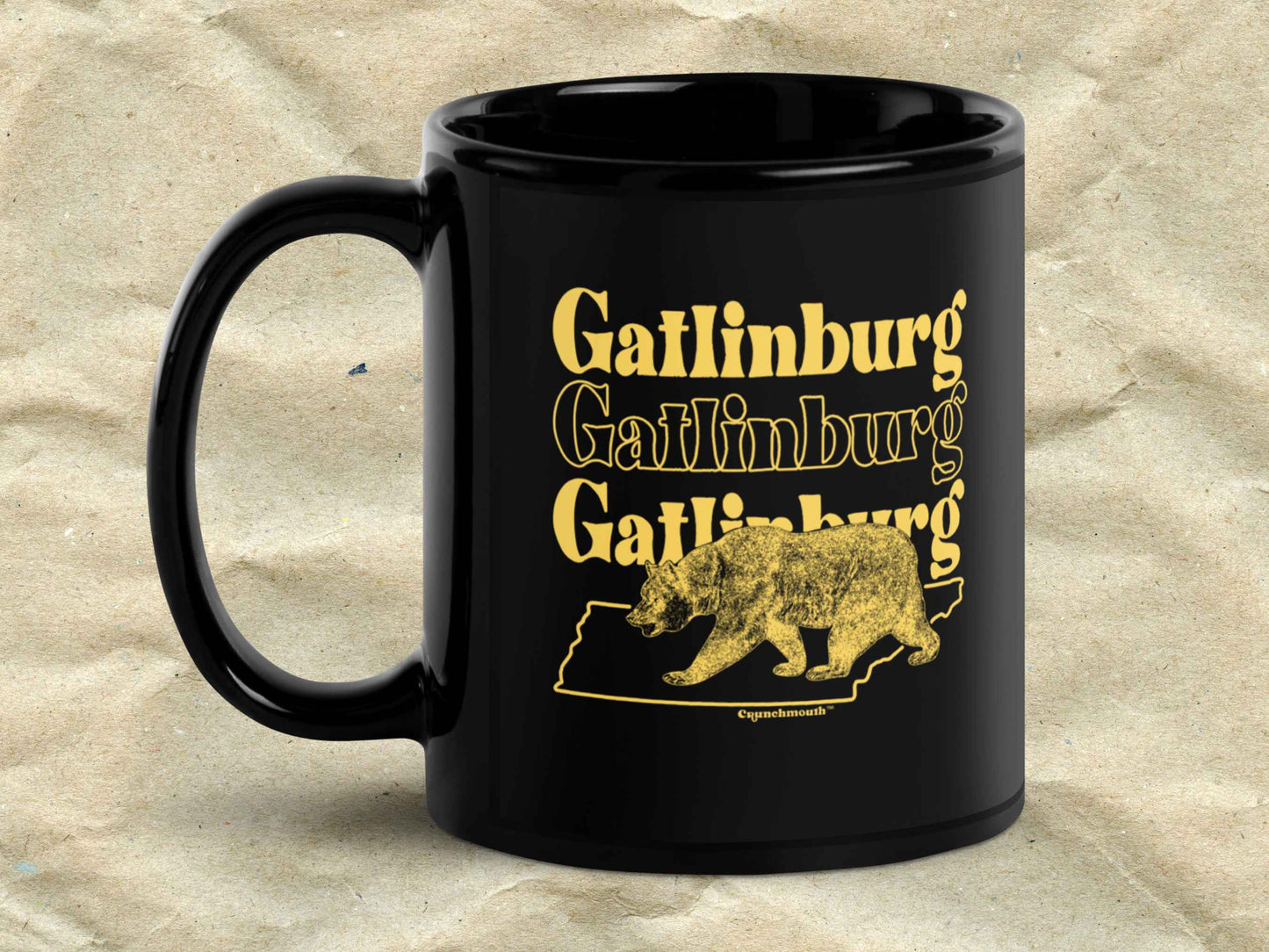 gatlinburg coffee mug, 11oz, black ceramic, handle on left, brown textured background