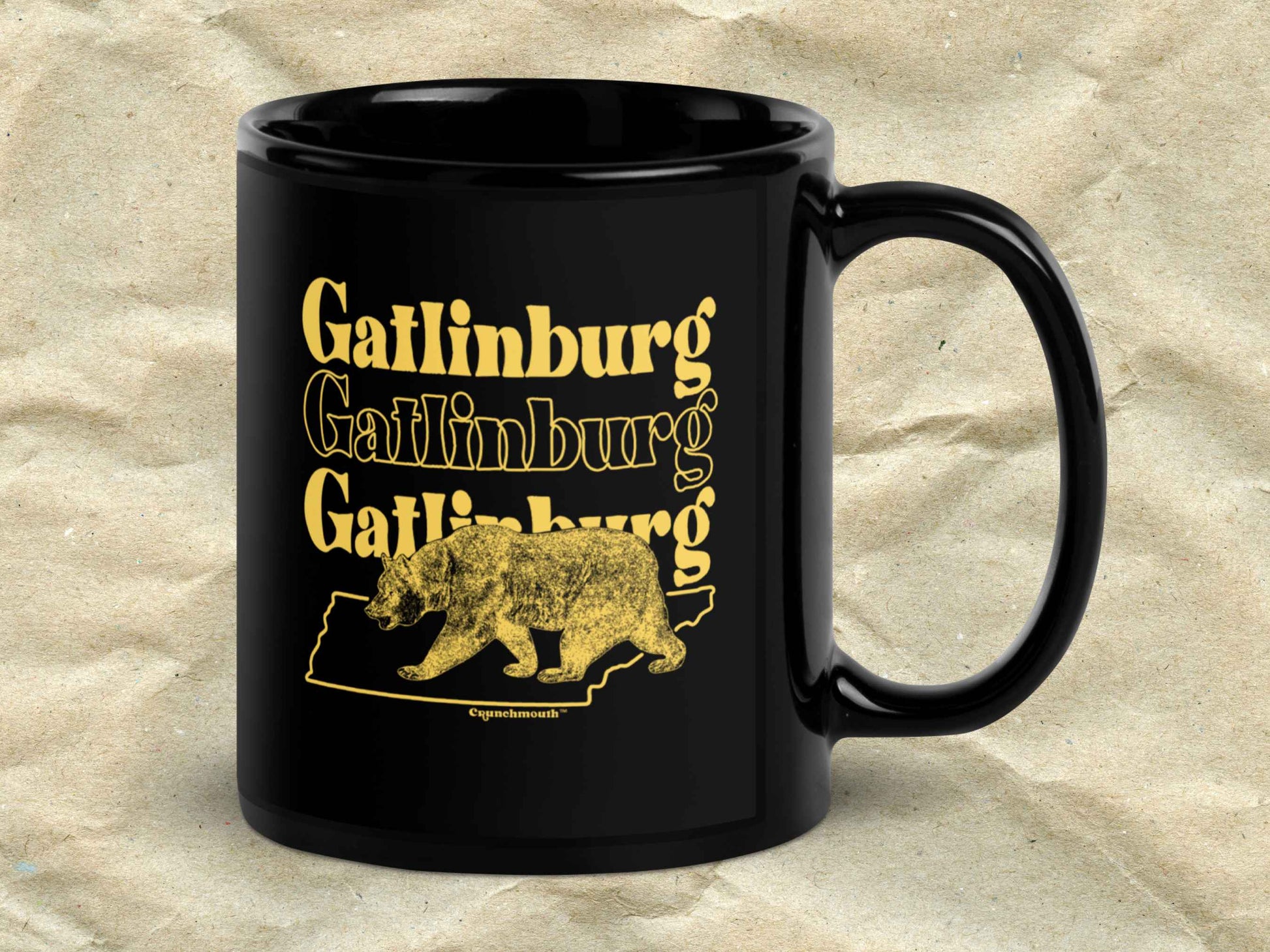 gatlinburg coffee mug, 11oz, black ceramic, handle on right, brown textured background