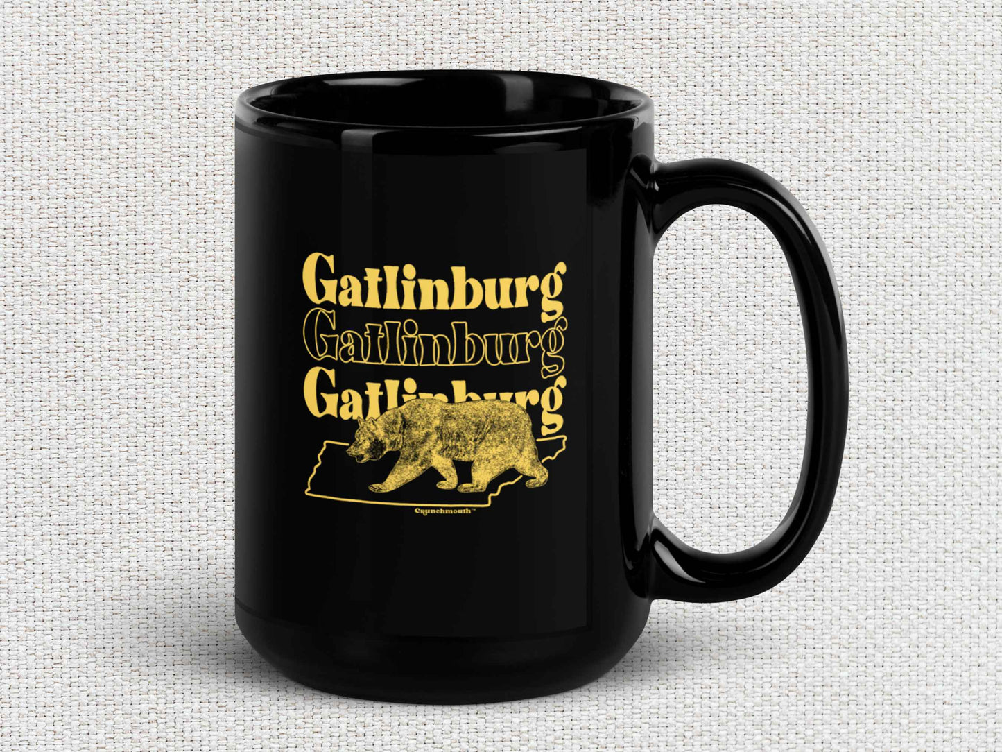 gatlinburg coffee mug, 15oz, black ceramic, handle on right, light color textured background