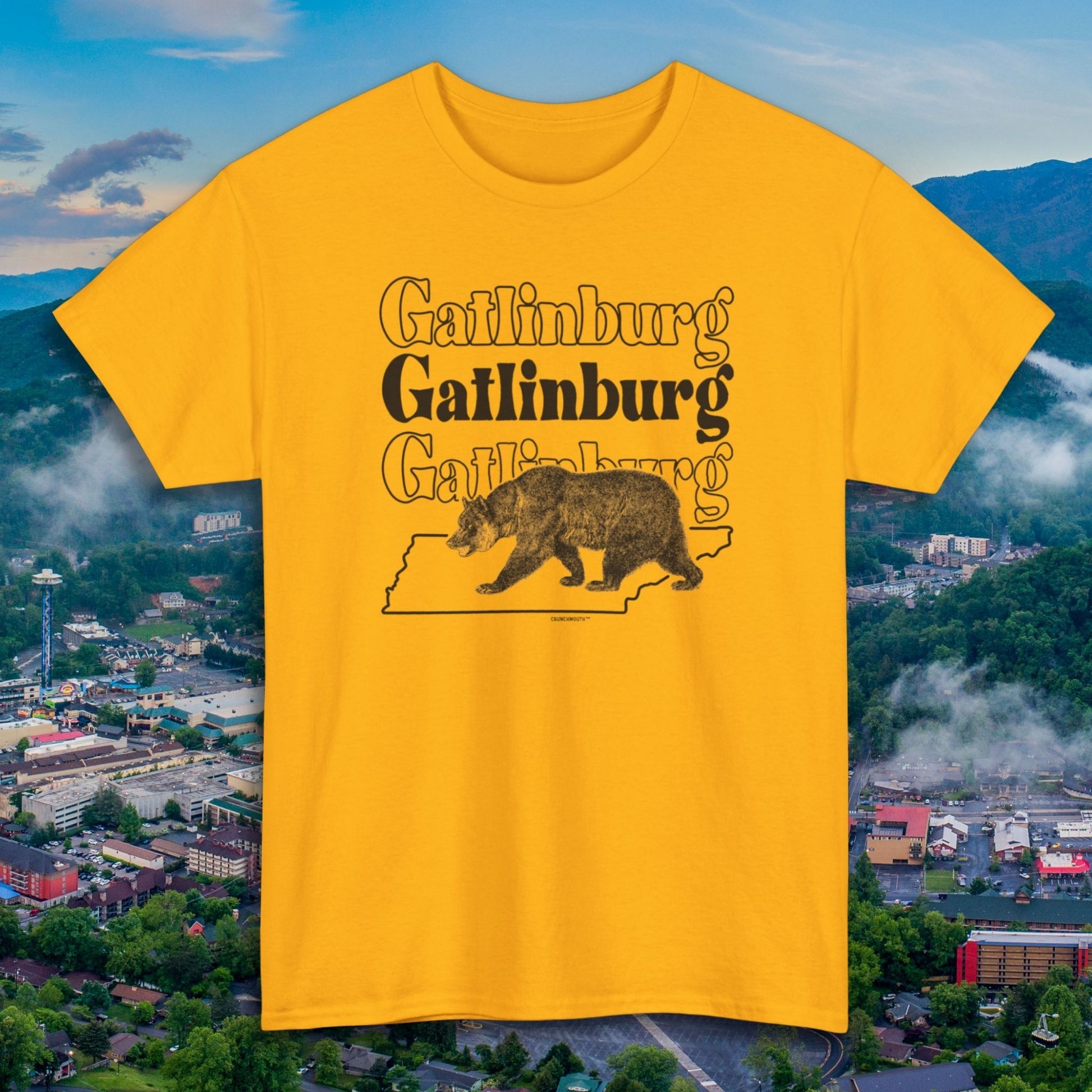 gatlinburg shirt, front, gold color, aerial view of gatlinburg background