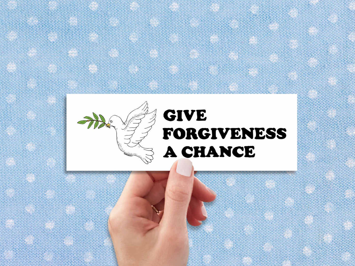 give forgiveness a chance bumper sticker, hand display, polka dot fabric background
