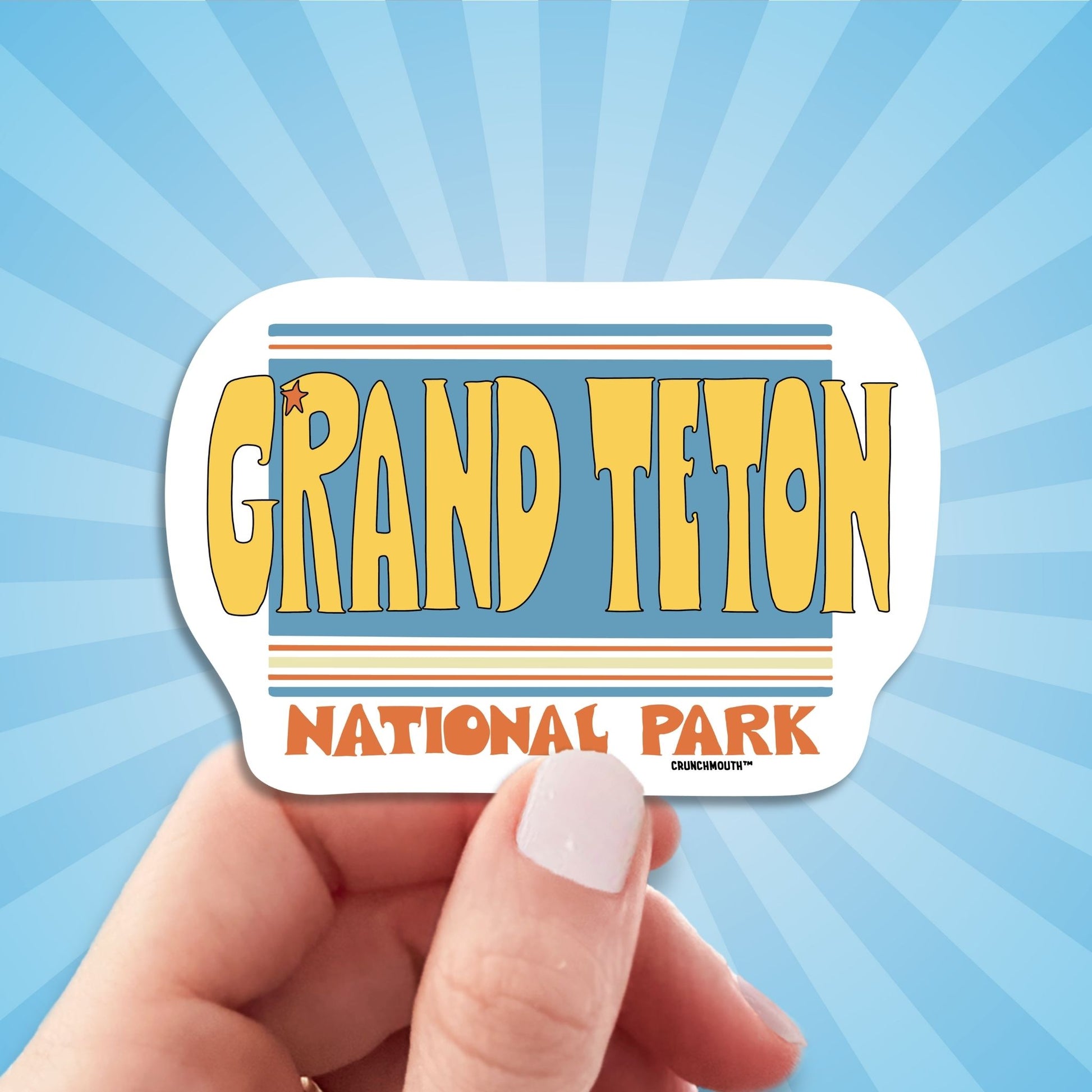 grand teton national park travel luggage sticker, hand display, sun rays design background
