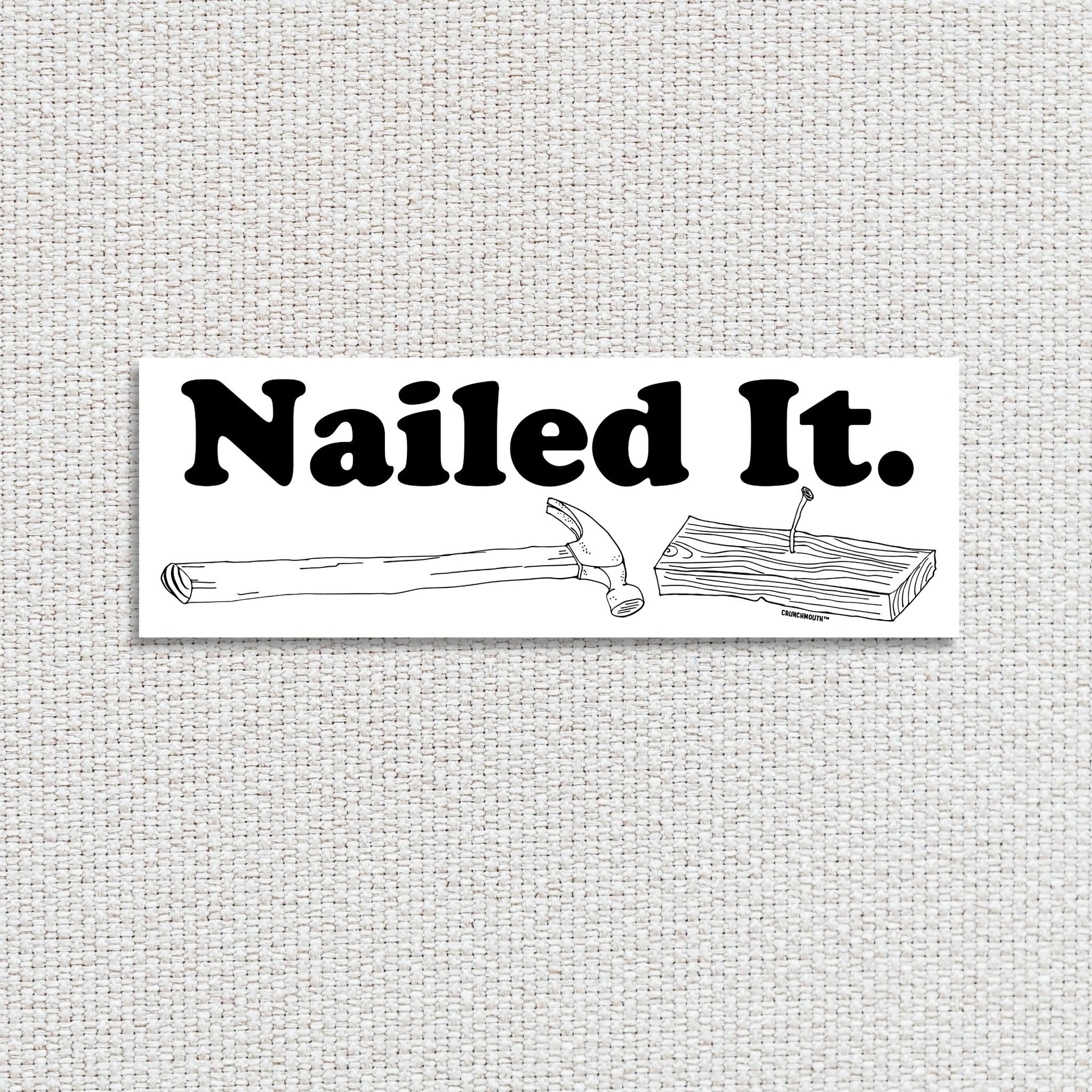 hammer and nail bumper sticker, nailed it, textured fabric background
