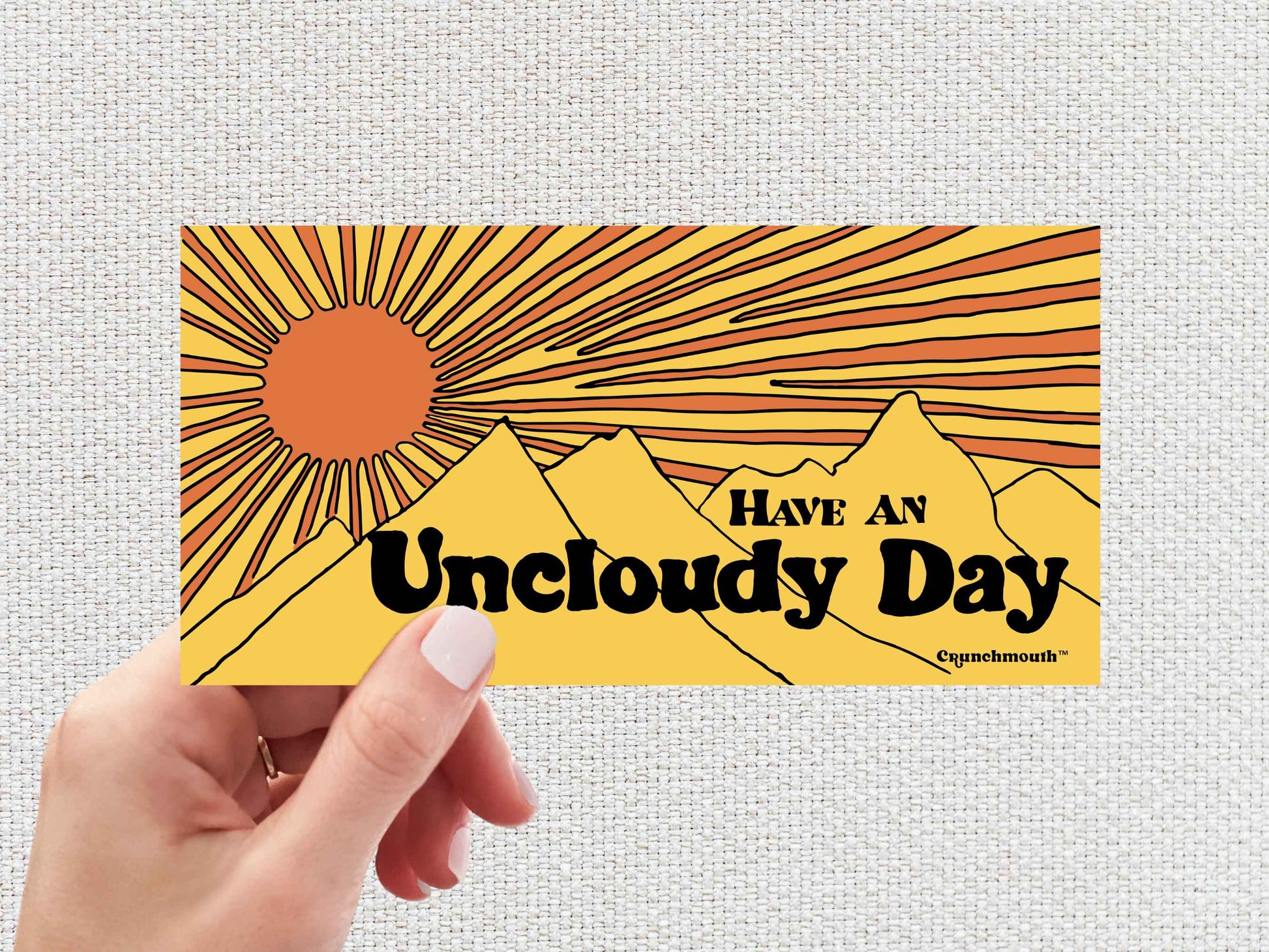 have an uncloudy day bumper sticker, sunshine sticker, hand display, white textured background