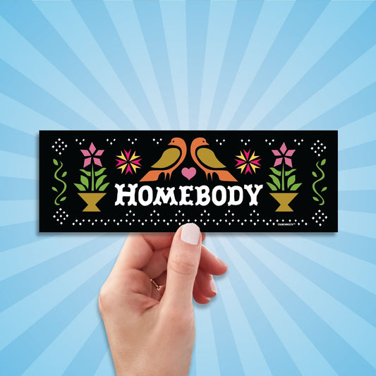 homebody bumper sticker, hand display, sun rays design background

