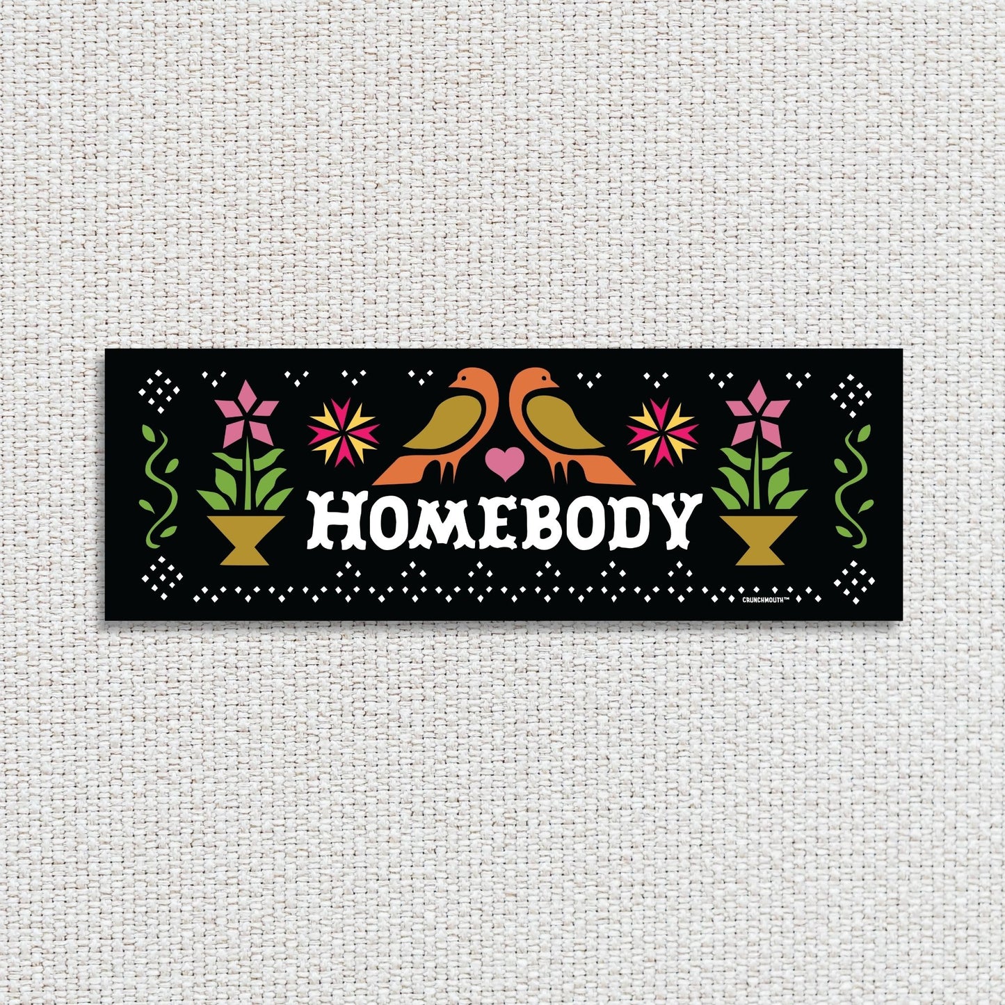 homebody bumper sticker, textured fabric background
