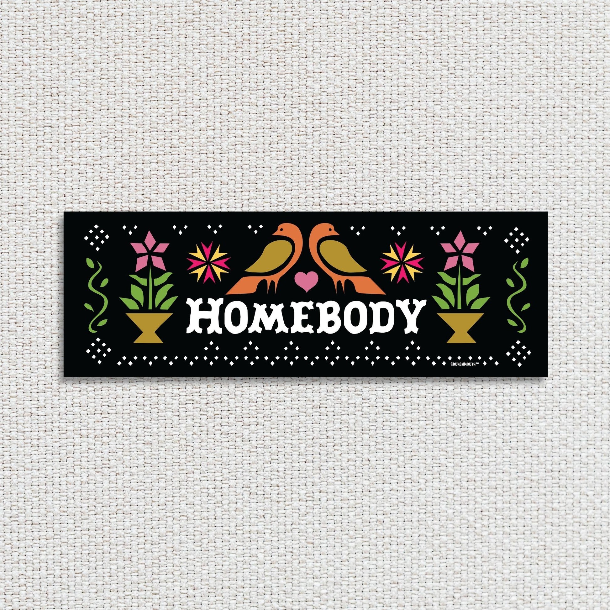 homebody bumper sticker, textured fabric background

