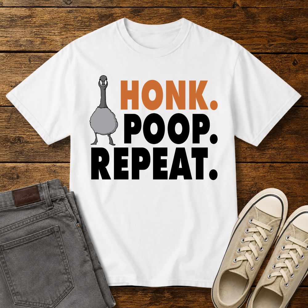 white graphic T-shirt mockup featuring a goose illustration and the phrase “Honk. Poop. Repeat.” in bold orange and black lettering, styled with gray jeans and beige sneakers on a rustic wood background.