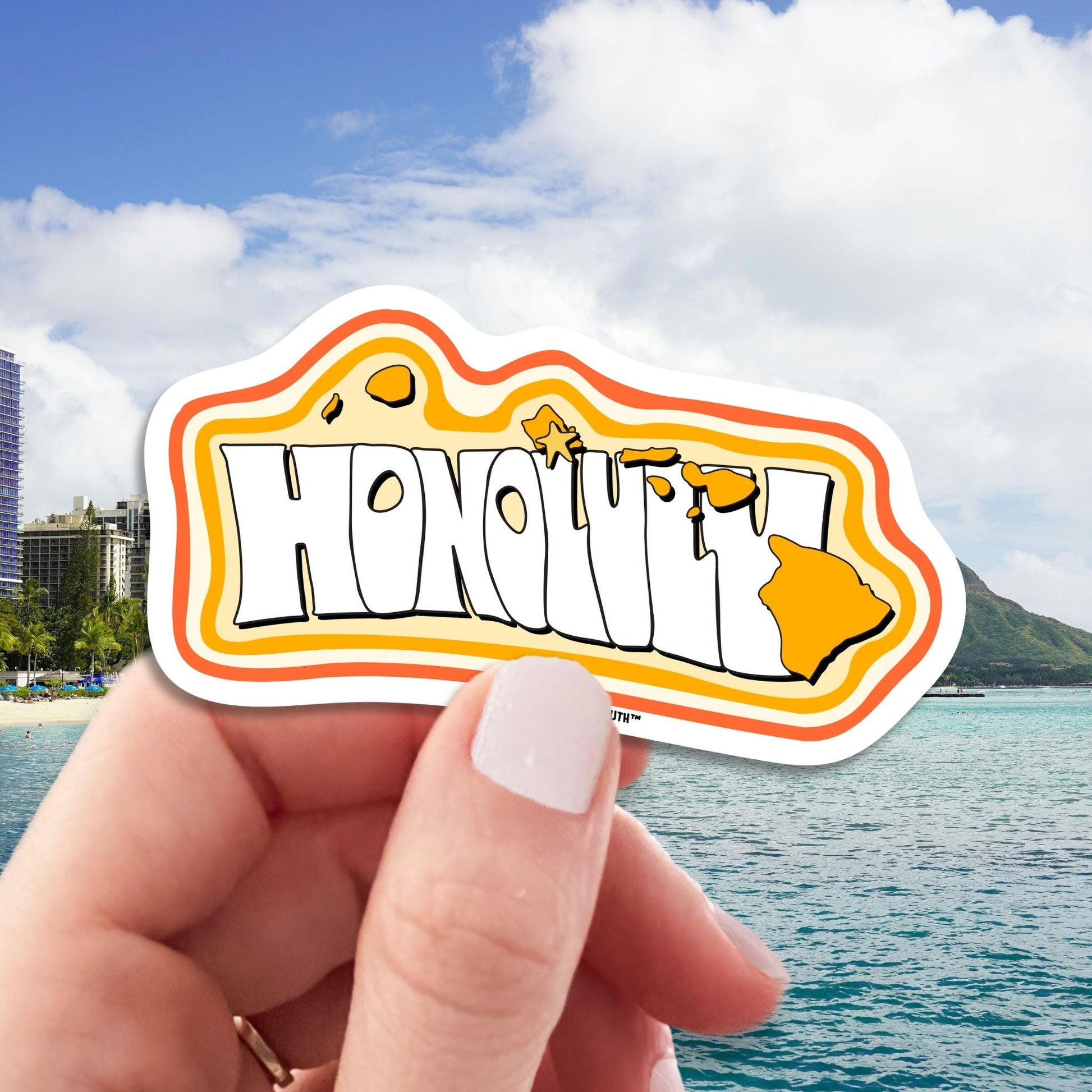 Honolulu travel luggage sticker, hand display, Waikiki Beach with Diamond Head in Honolulu background
