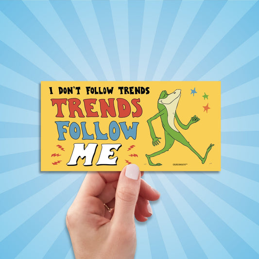 i don't follow trends, trends follow me bumper sticker, hand display, sun rays design background