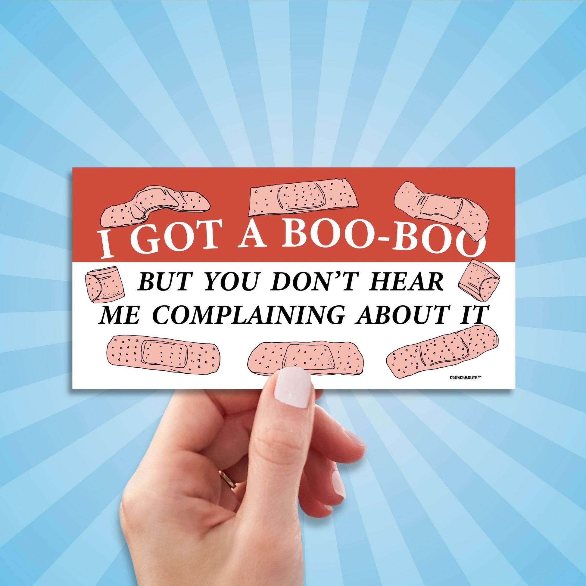 i got a boo-boo but you don't hear me complaining about it bumper sticker, hand display, sun rays design background
