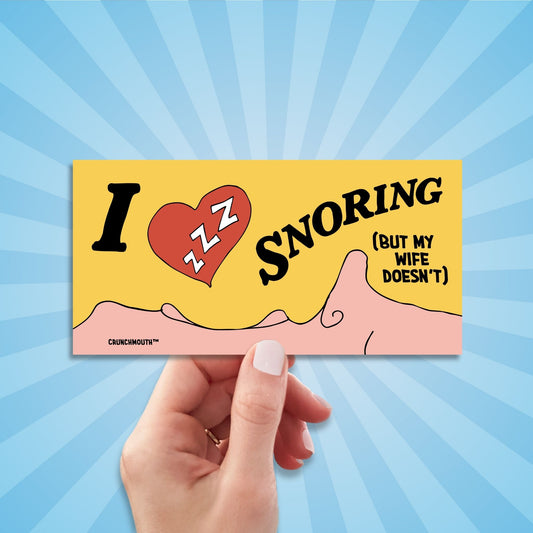 i love snoring but my wife doesn't funny bumper sticker, hand display, sun rays design background
