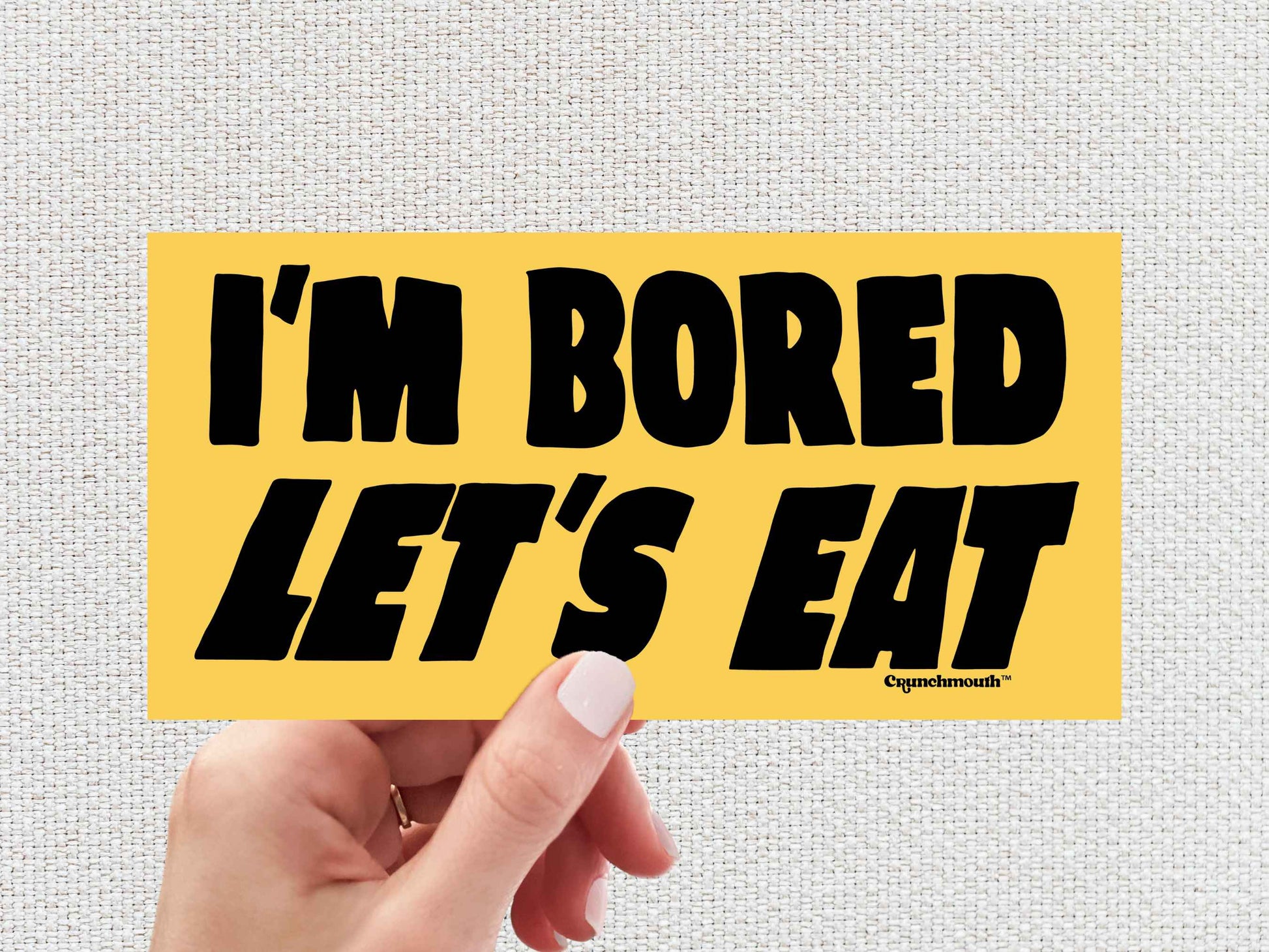 i'm bored let's eat funny bumper sticker, hand display, white textured background