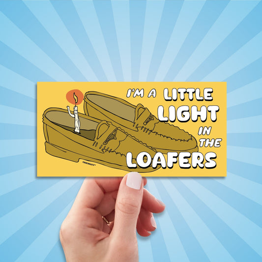i'm a little light in the loafers bumper sticker, hand display, sun rays design background
