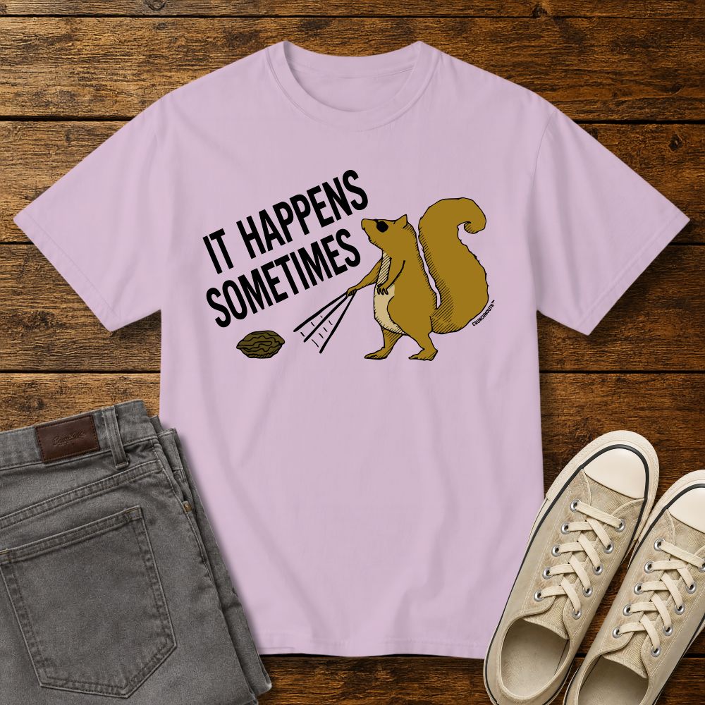 Funny squirrel graphic t-shirt on orchid color tee with ‘It Happens Sometimes’ text, shown in flat lay mockup with jeans and sneakers on rustic wood background