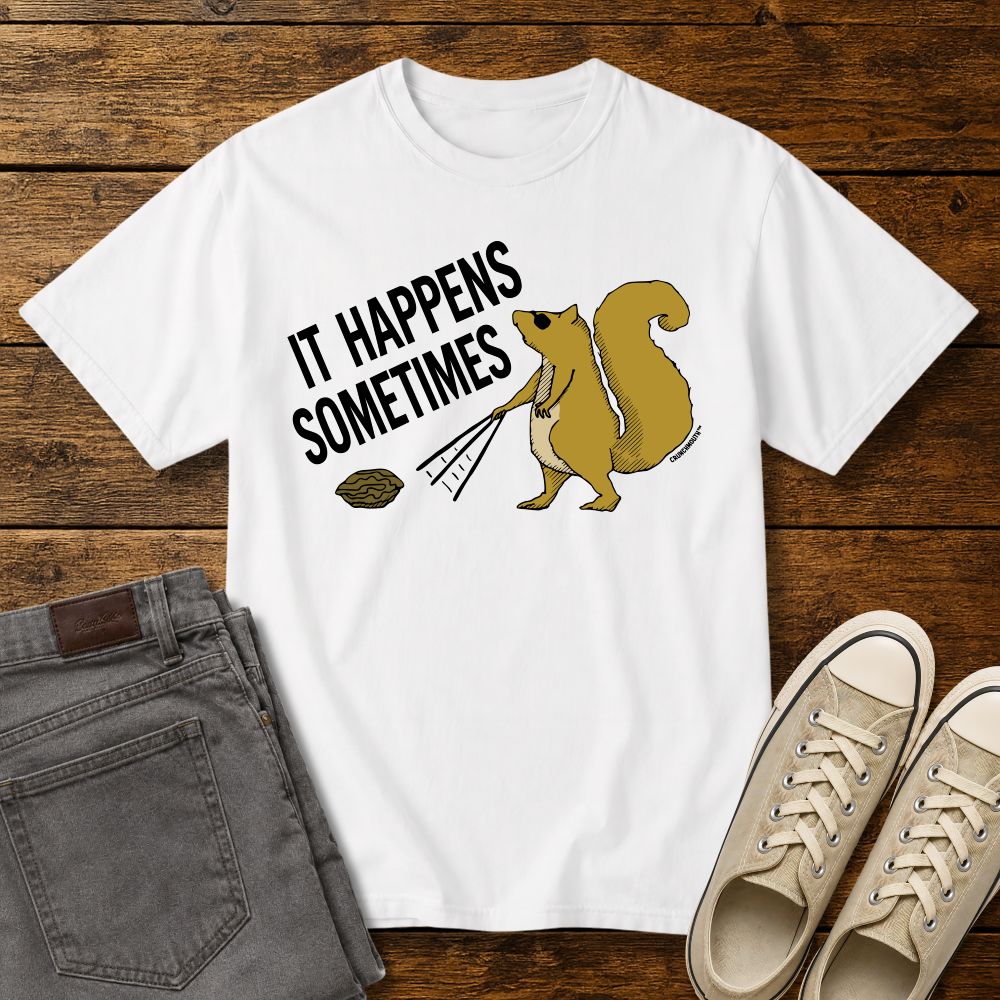 Funny squirrel graphic t-shirt on white tee with ‘It Happens Sometimes’ text, shown in flat lay mockup with jeans and sneakers on rustic wood background