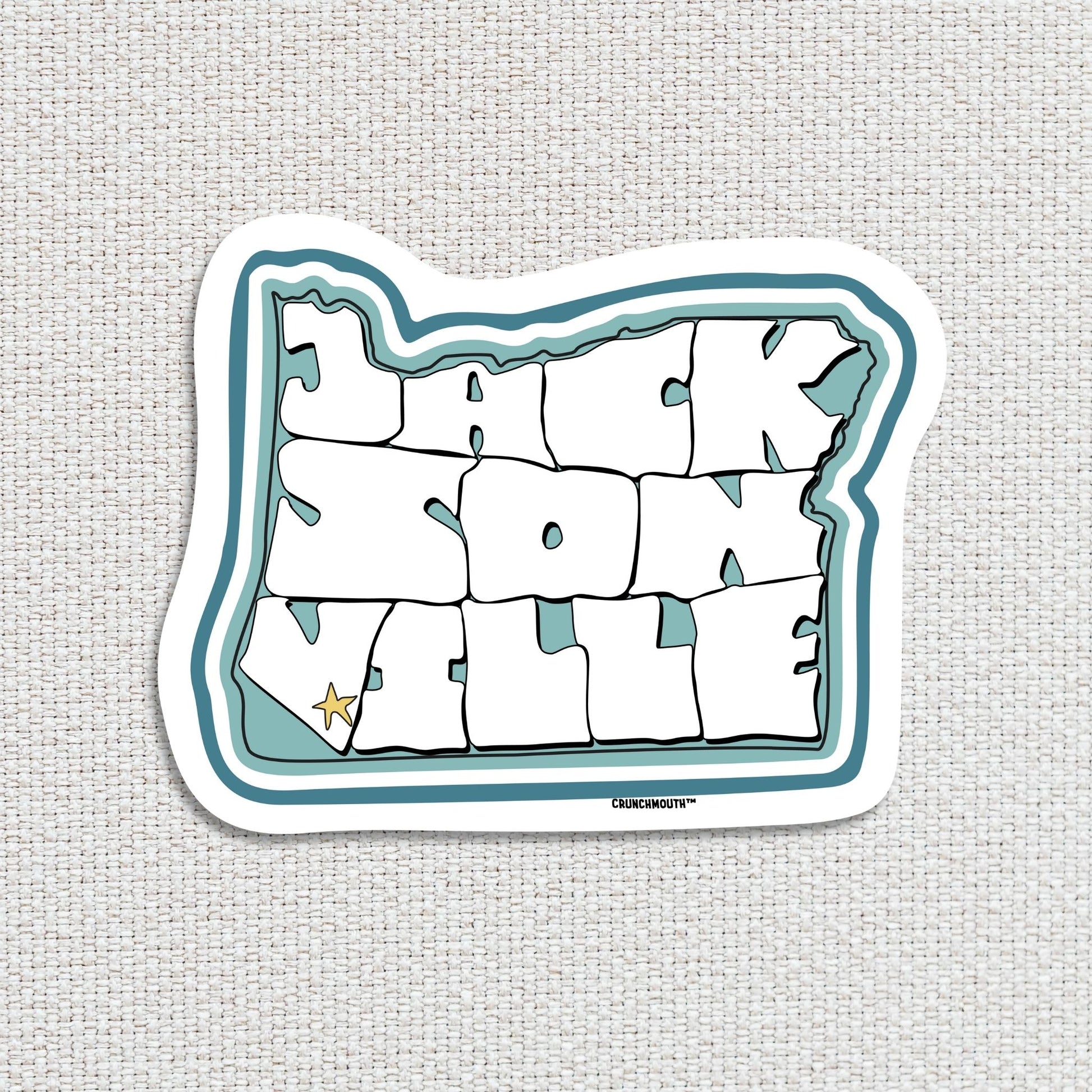 Jacksonville oregon travel luggage sticker, textured fabric background
