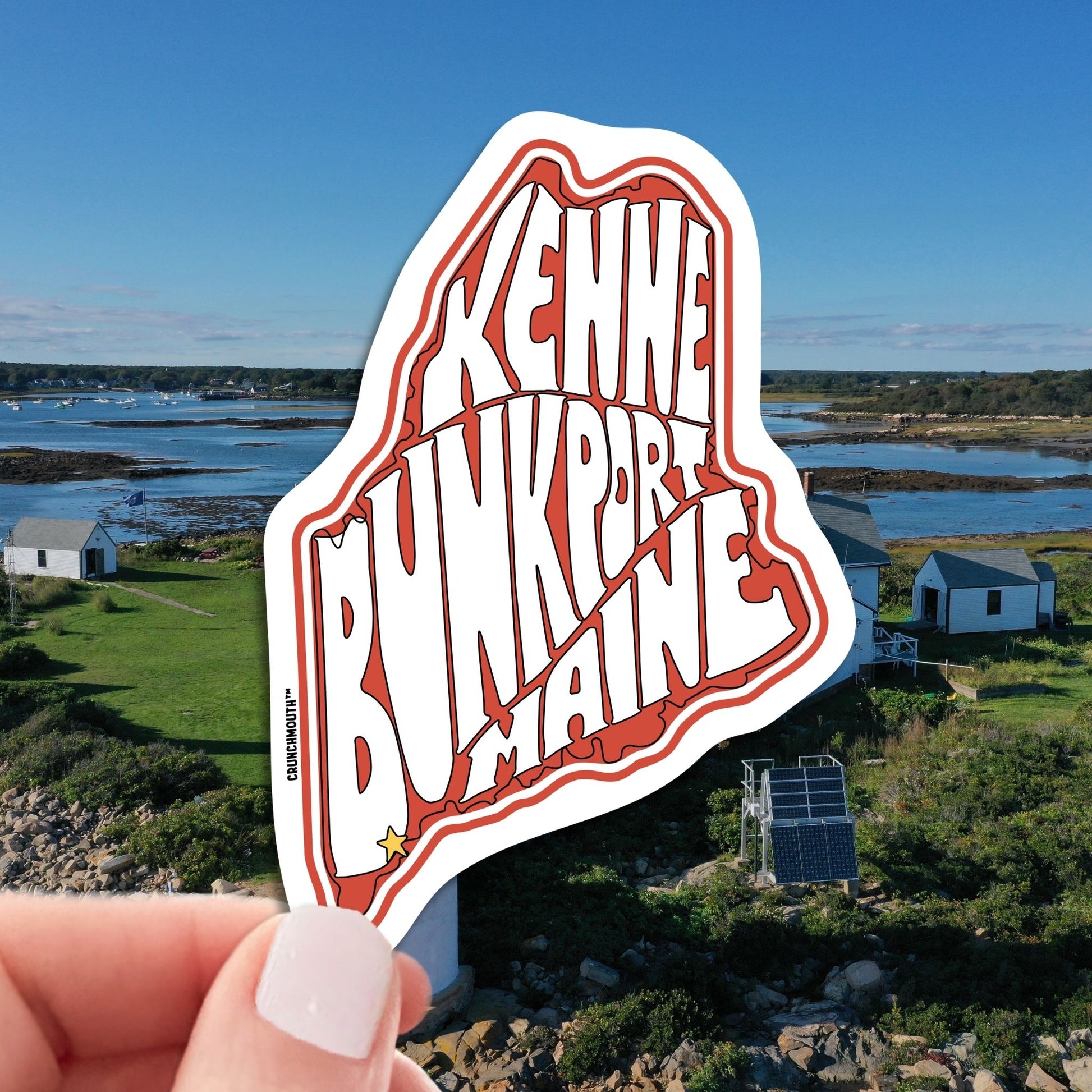 Kennebunkport travel luggage sticker, hand display, Kennebunkport coast background
