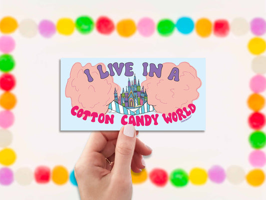 i live in a cotton candy world bumper sticker, hand display, gumdrops background