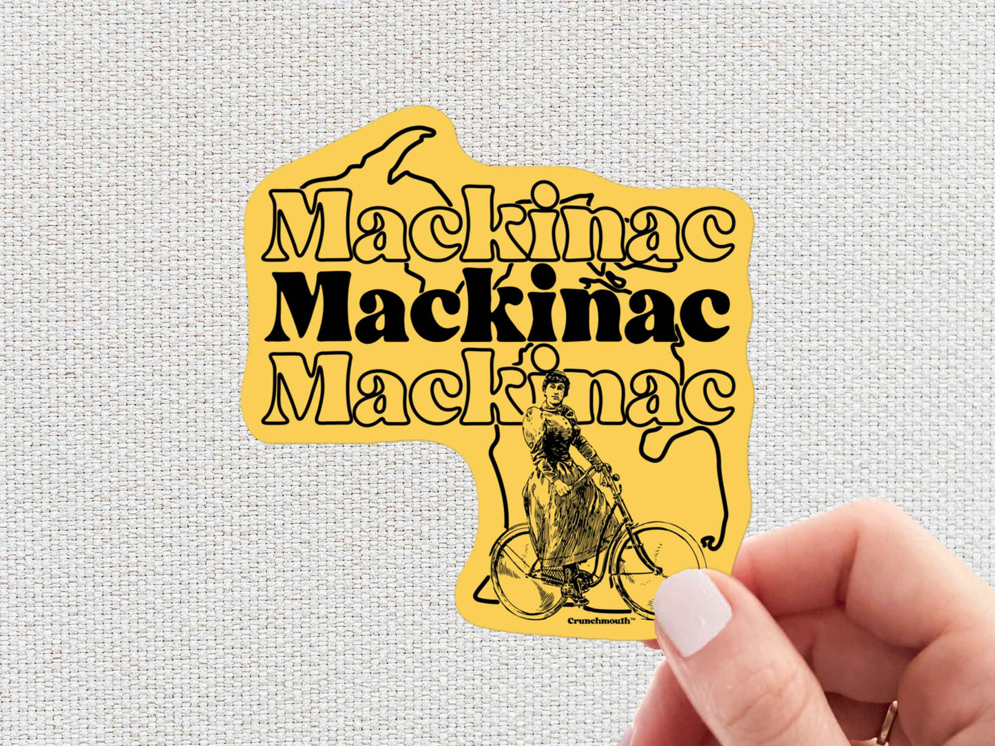 mackinac island sticker, hand display, white textured background