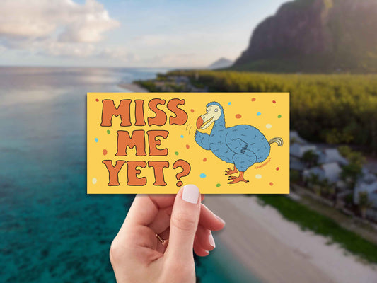 dodo bird bumper sticker, miss me yet?, funny bumper stickers, hand display, aerial photo of island coast background