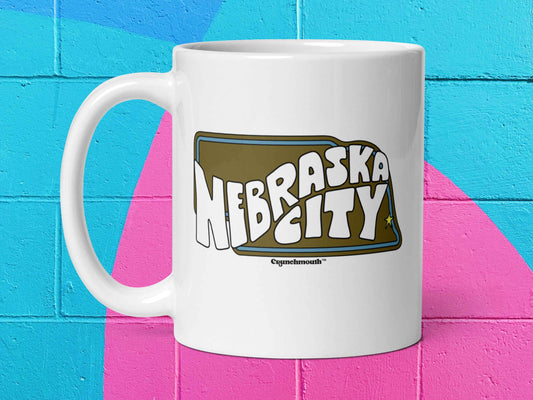 nebraska city mug, souvenir coffee mugs, 11 oz, handle on left, vibrant colorful cinder block wall background