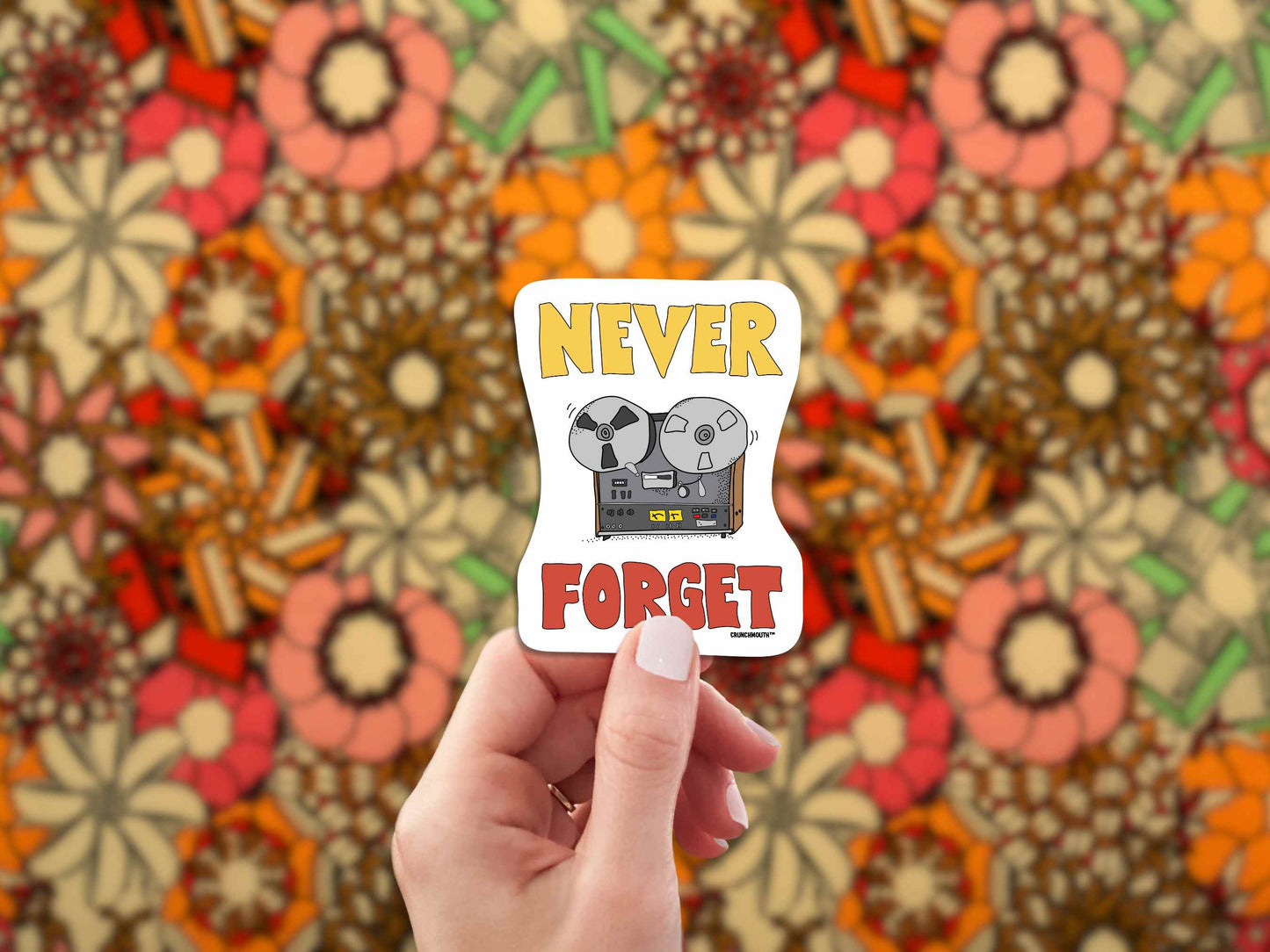 reel-to-reel player never forget sticker, hand display, 1960s floral pattern fabric background