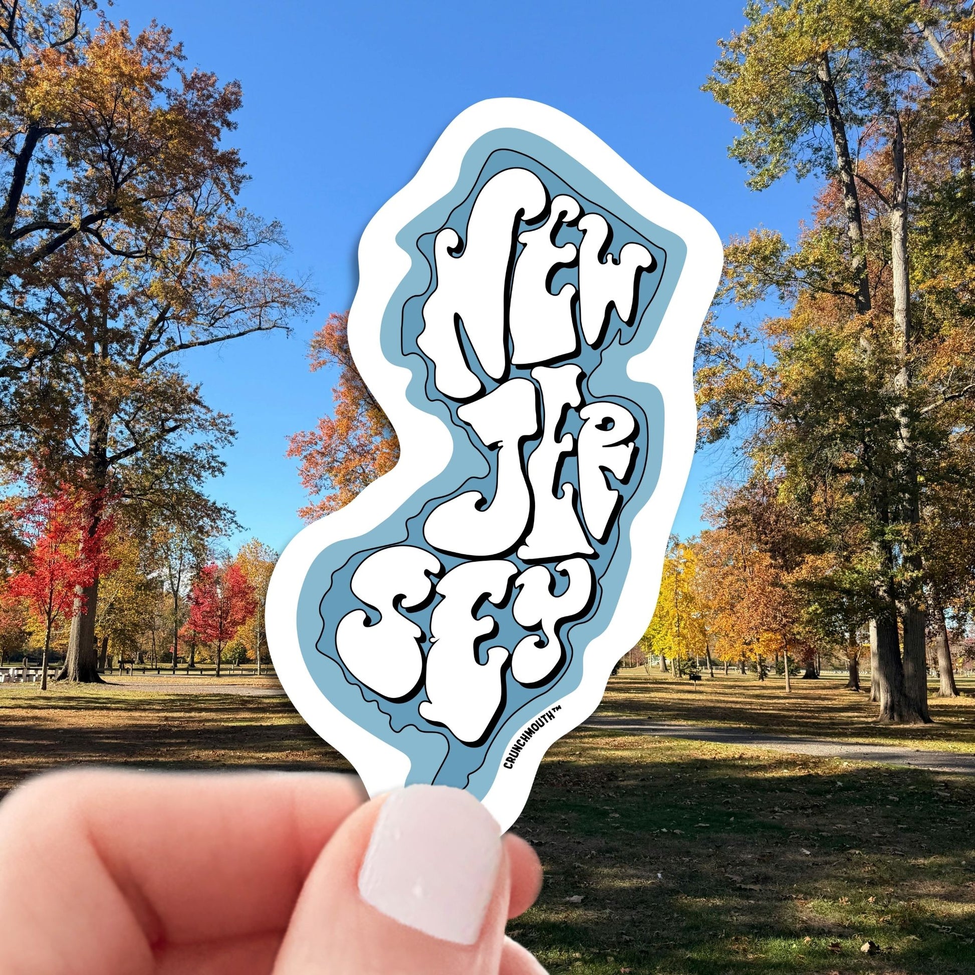 new jersey travel luggage sticker, hand display, autumn in new jersey background
