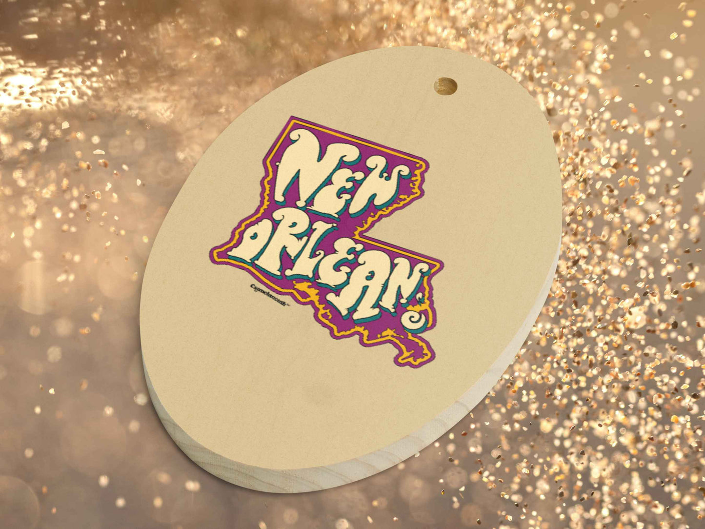 nola wooden ornament, back, gold glitter background