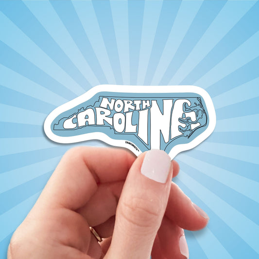 north carolina travel luggage sticker, hand display, sun rays design background
