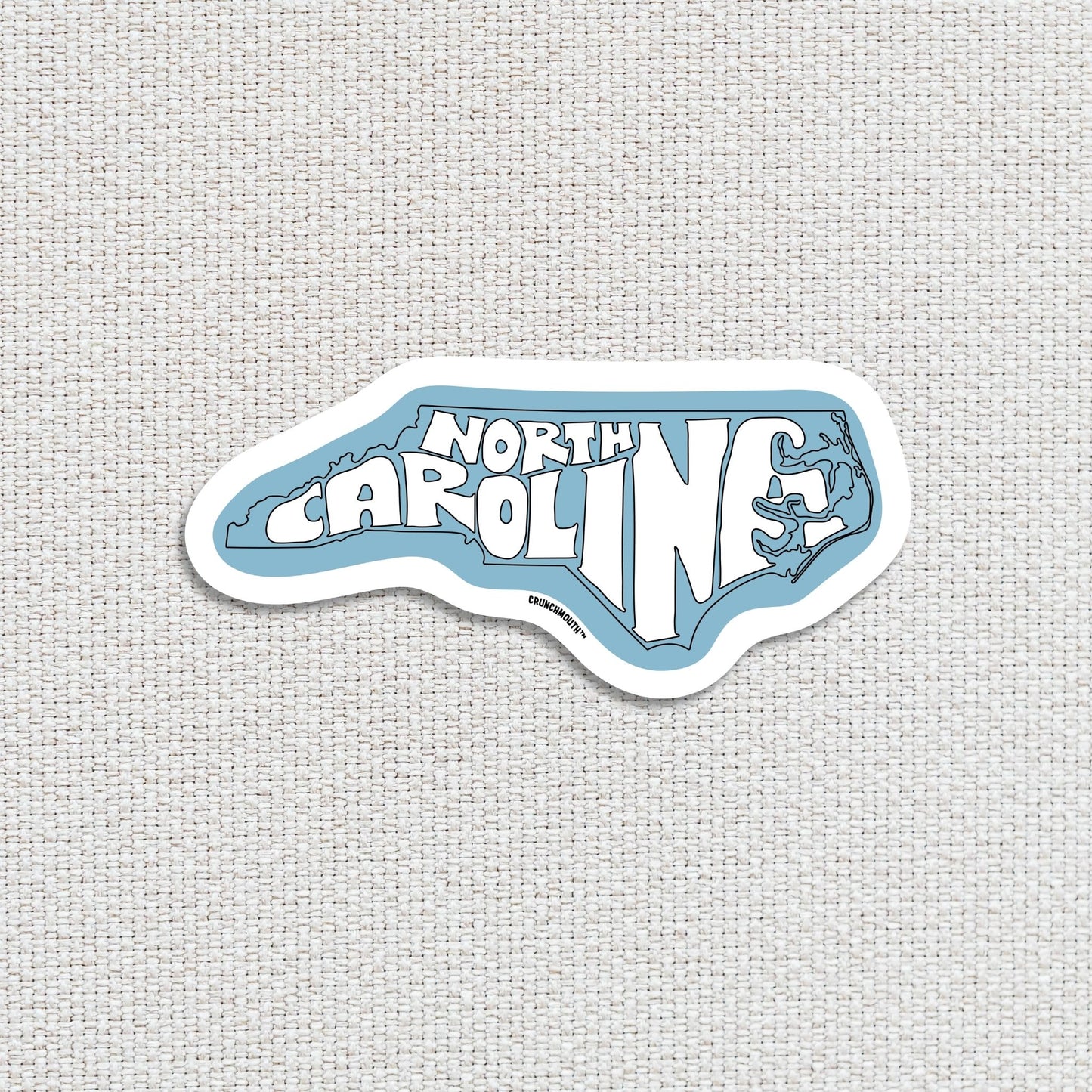 north carolina travel luggage sticker, textured fabric background
