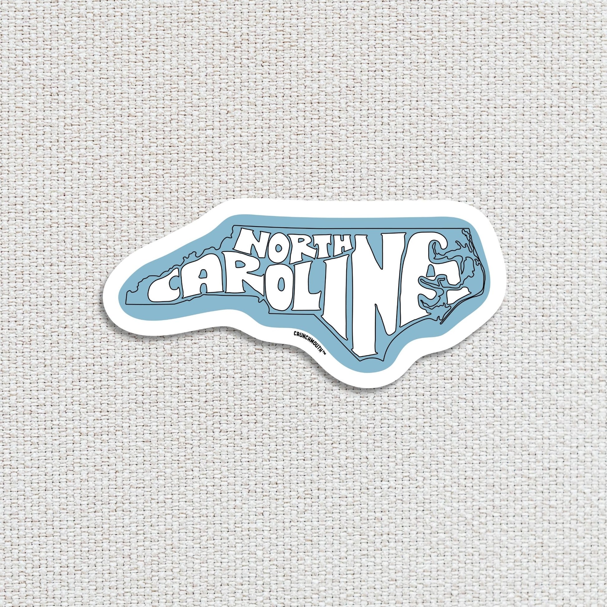 north carolina travel luggage sticker, textured fabric background
