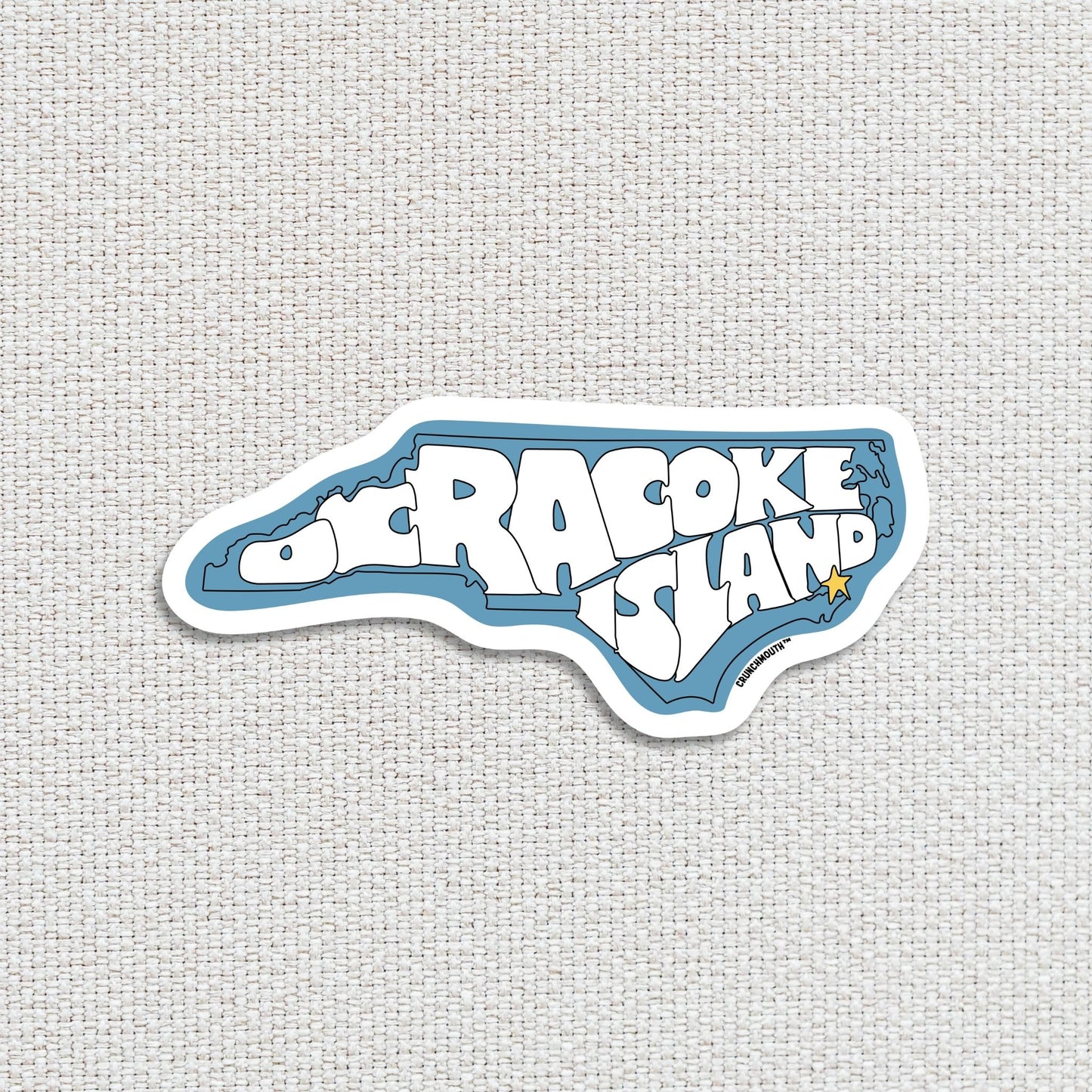 Ocracoke island travel luggage sticker, textured fabric background
