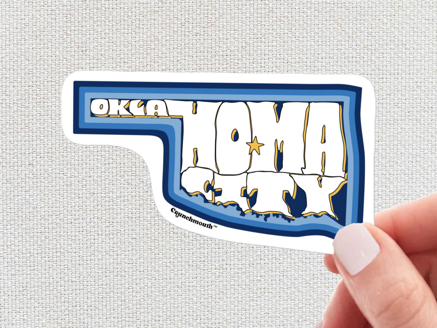 oklahoma city travel luggage sticker, hand display, white textured background