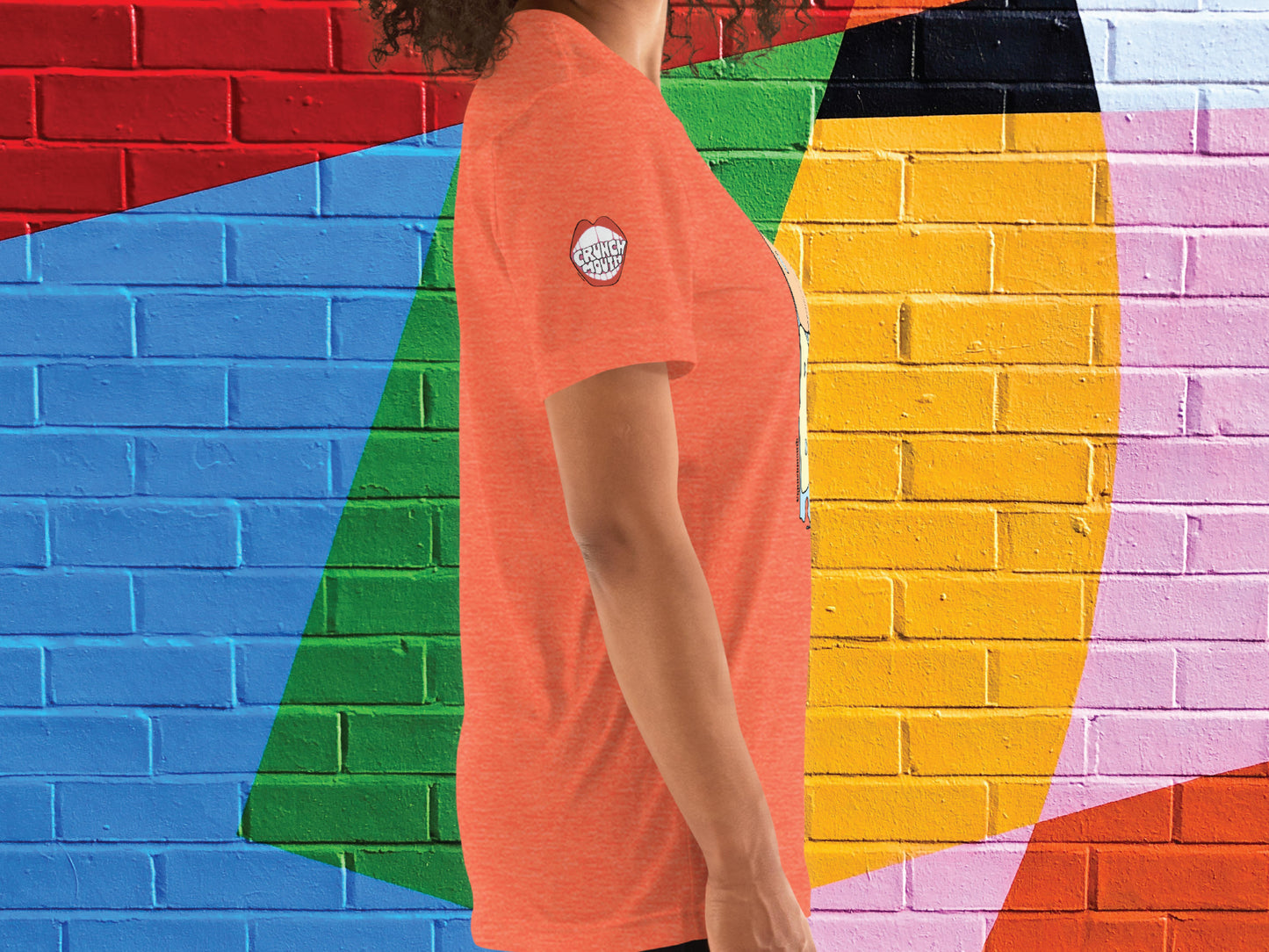 orange beach shirt, right side, female, colorful brick wall background