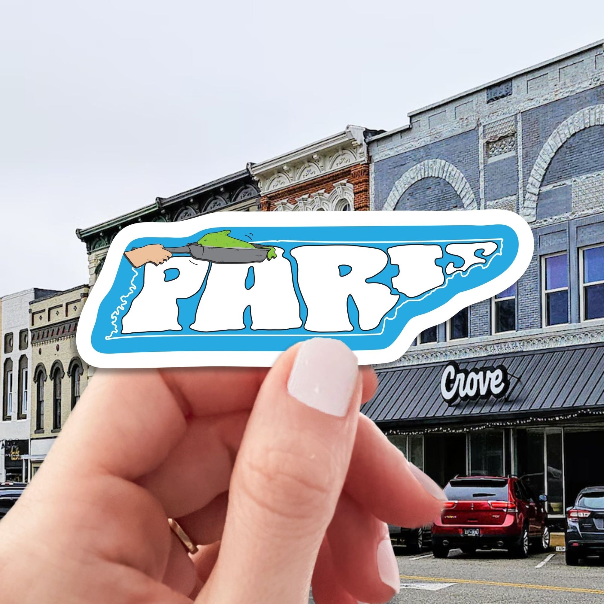 paris Tennessee world's biggest fish fry travel luggage sticker, hand display, downtown paris background
