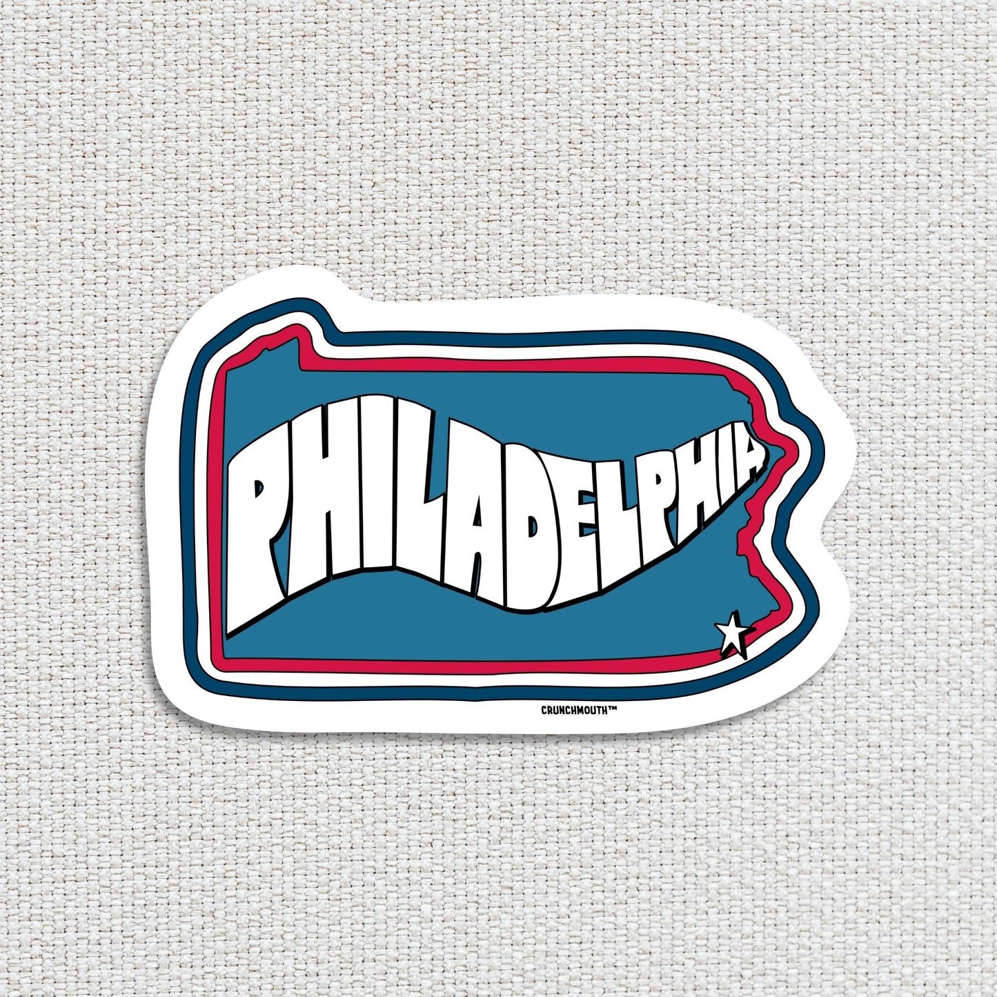 philadelphia travel luggage sticker, hand display, textured fabric background
