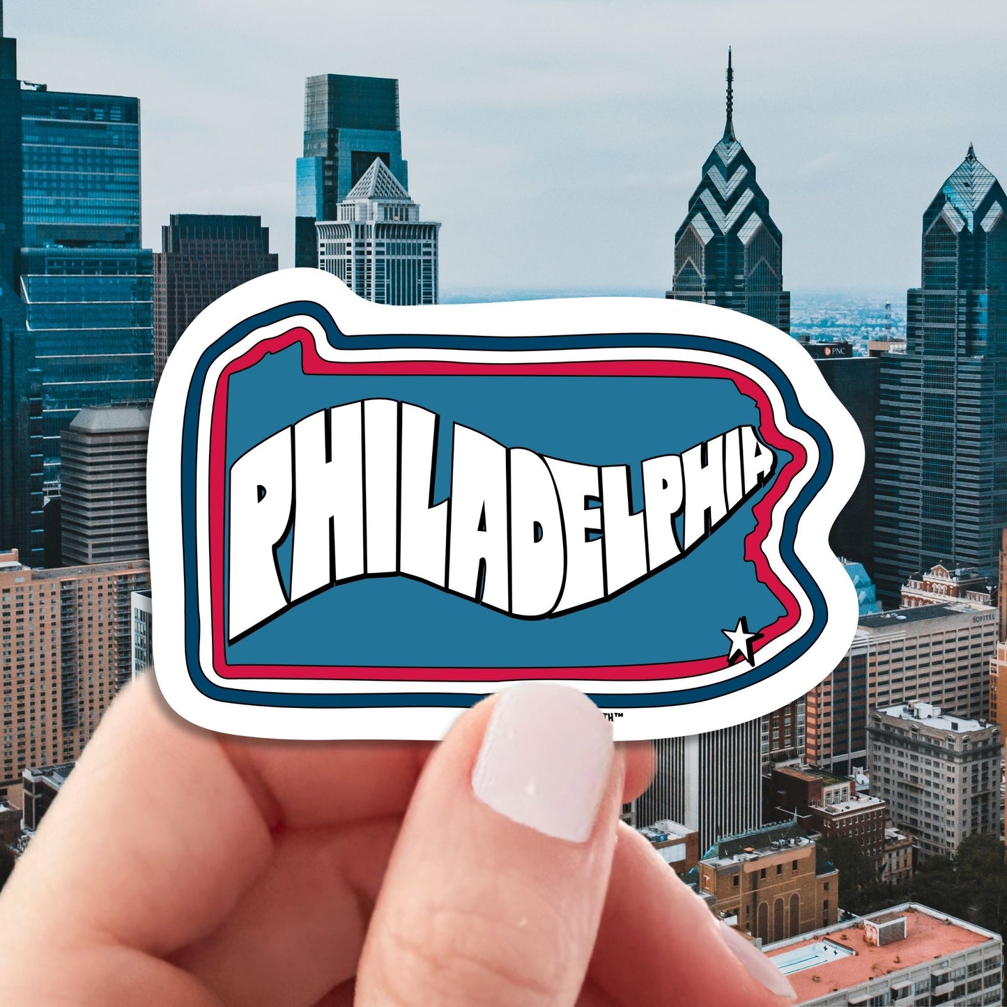philadelphia travel luggage sticker, hand display, skyline background
