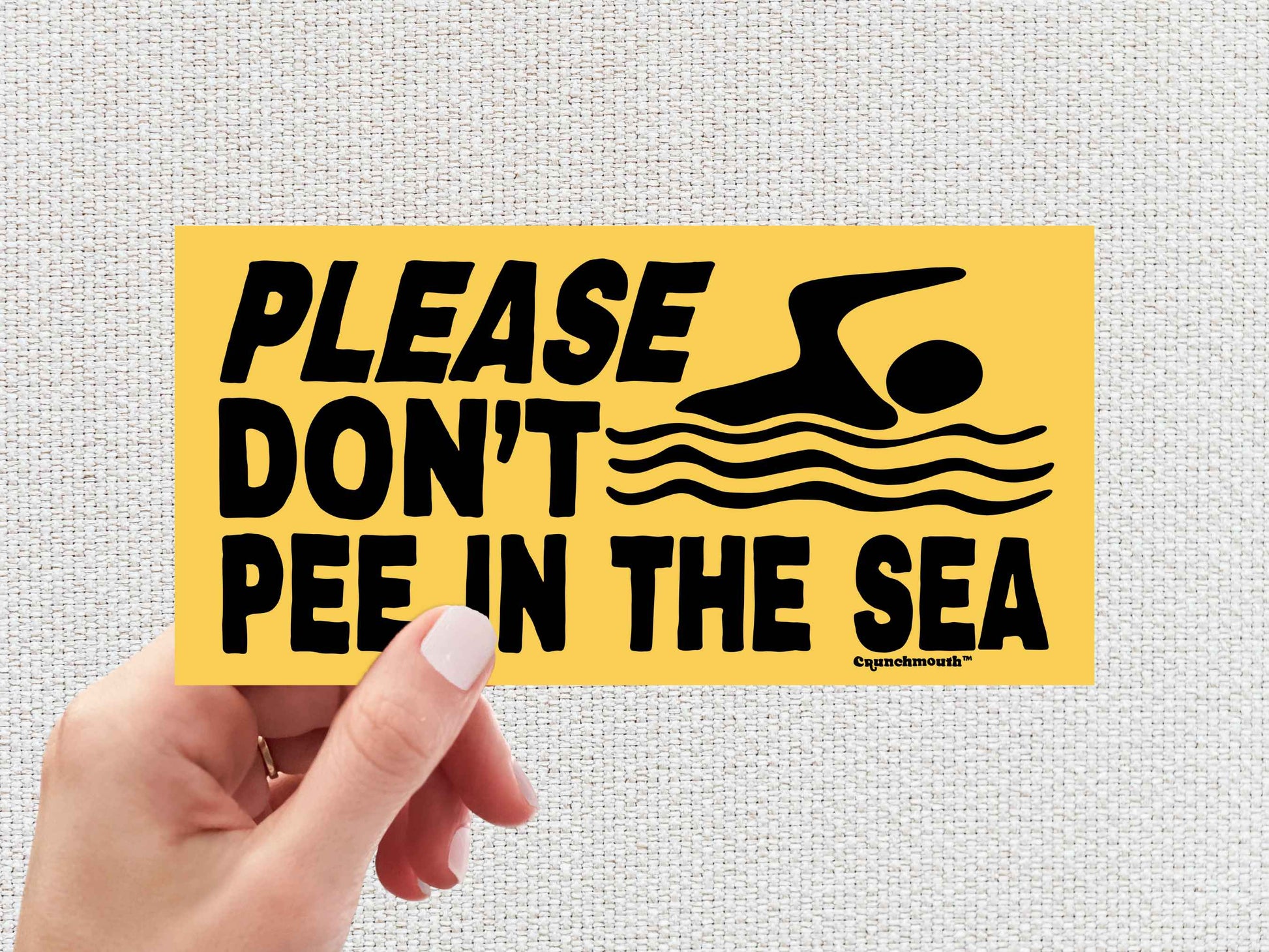 please don't pee in the sea, funny beach sticker, hand display, white textured background