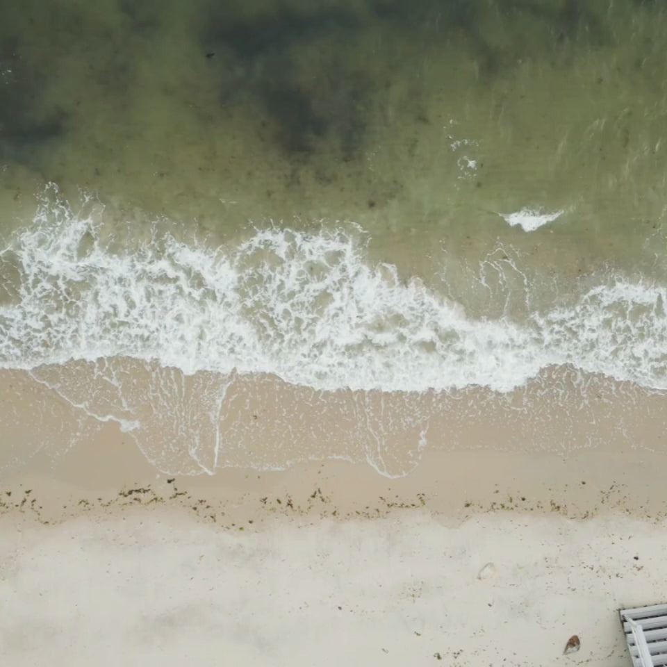 Nantucket island travel luggage sticker, hand display, ocean shore background