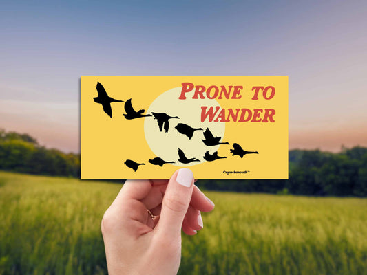 prone to wander bumper sticker, wild geese in the west, hand display, sunset over field background