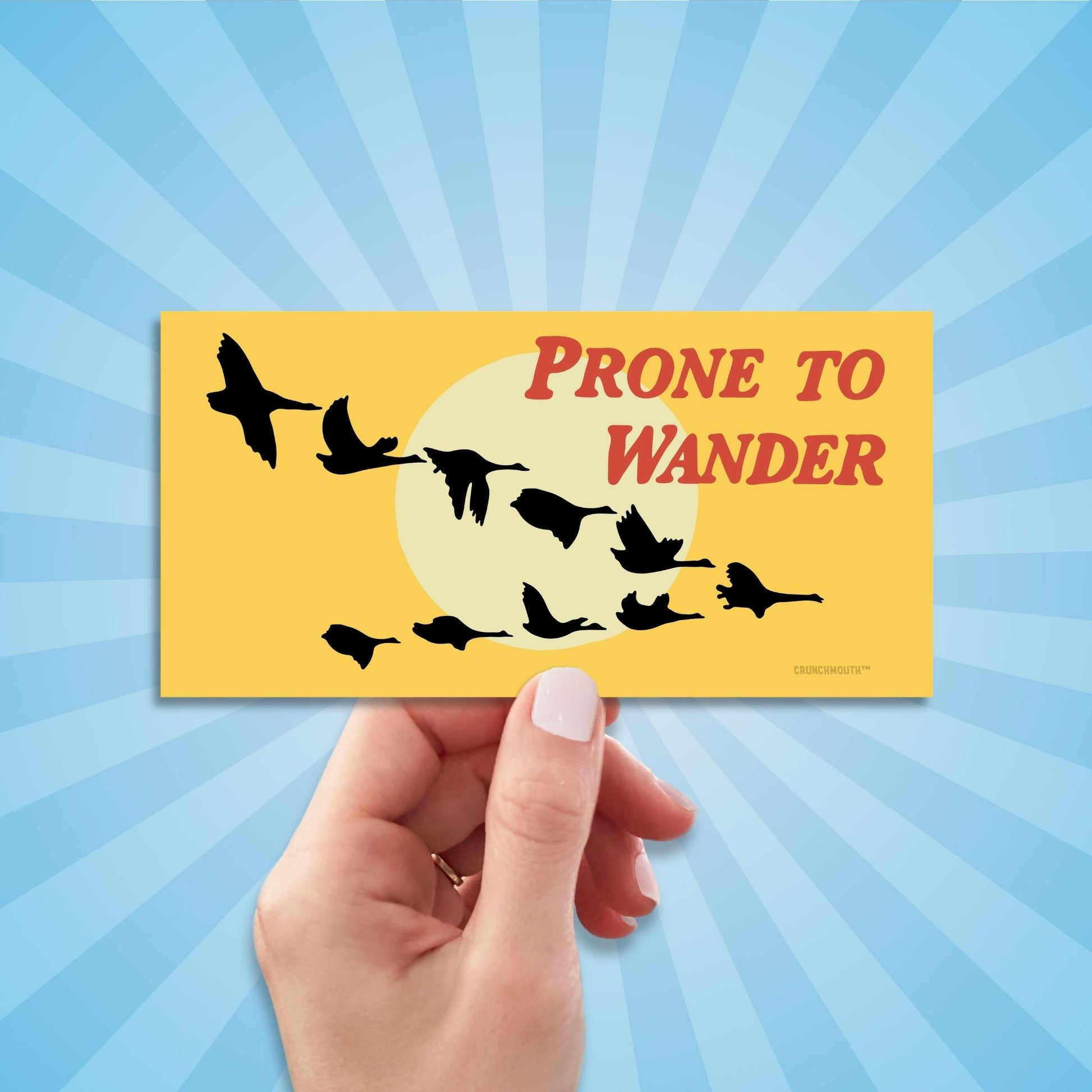 prone to wander Canada geese bumper sticker, hand display, sun rays design background
