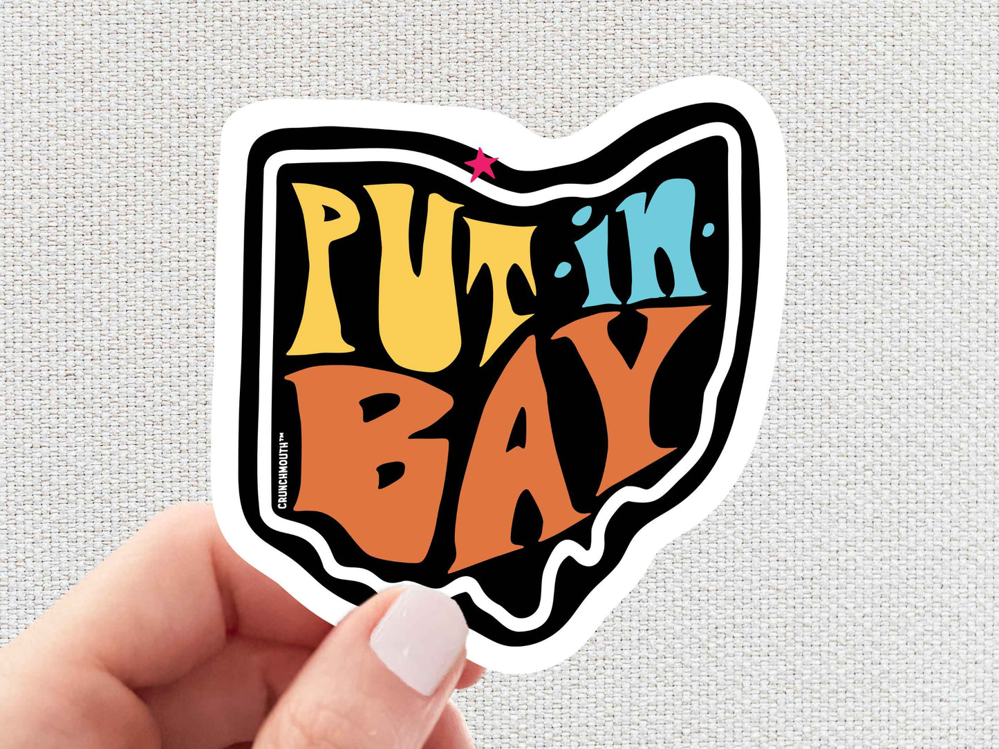 put in bay sticker, hand display, white textured background