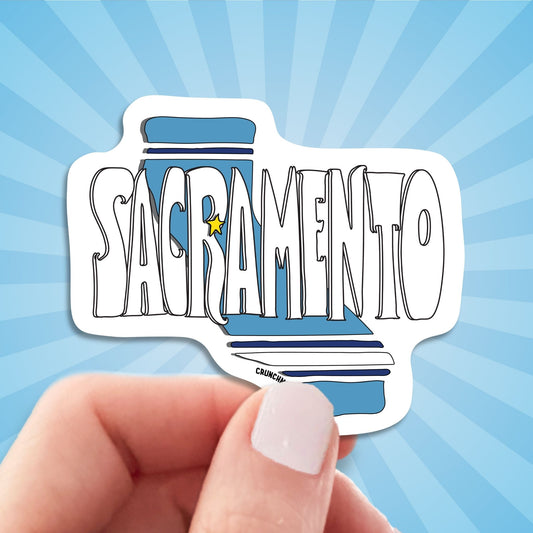 sacramento travel luggage sticker, hand display, sun rays design background
